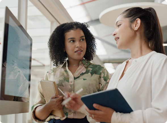 Two colleagues discussing an employee handbook review